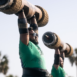 two men lifting giant weights over their heads
