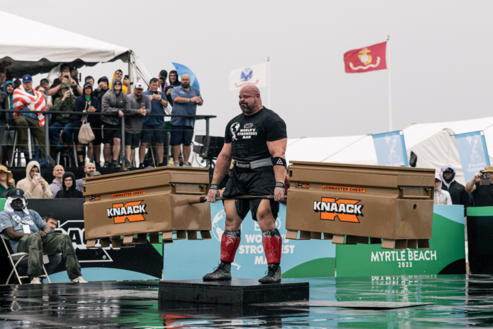 strong looking man lifting two knaack crates