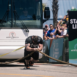 strong man pulling a coach sized bus