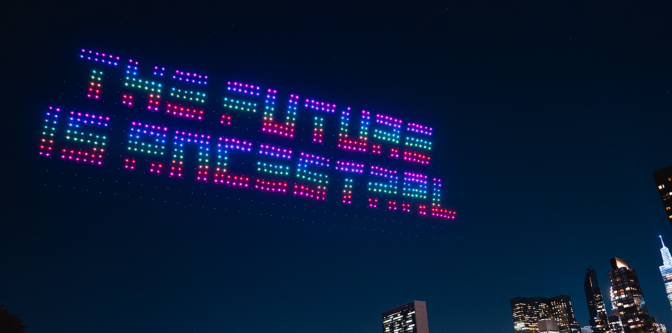 "the future is ancestral" drone projection in the sky