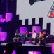 panel speakers sitting on custom stage with sqare pink towers