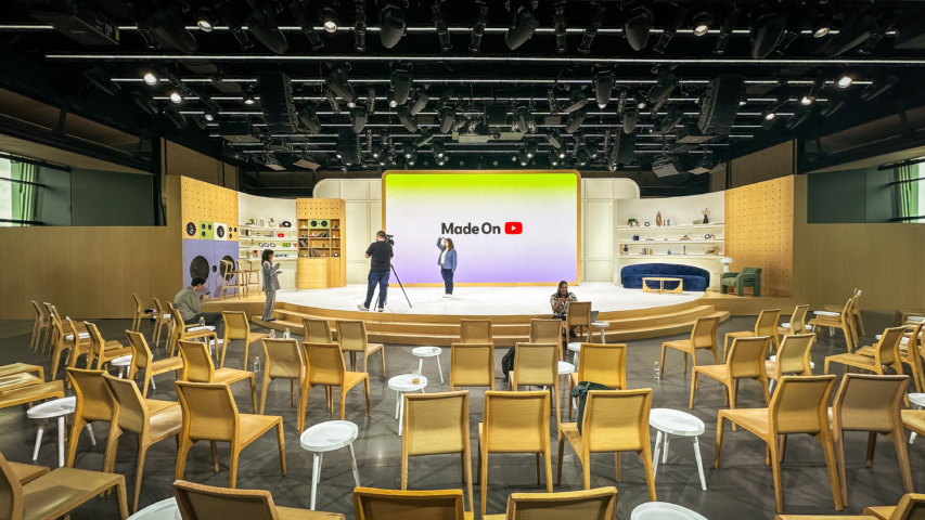 workers testing light levels on custom set for video production