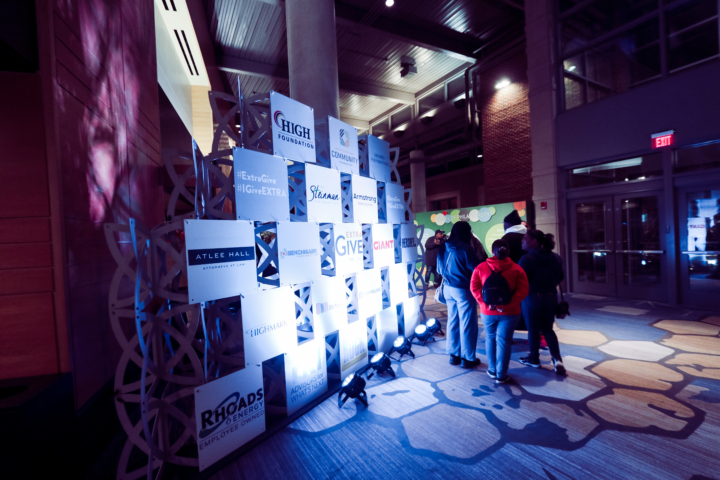 people walking past custom logo displays