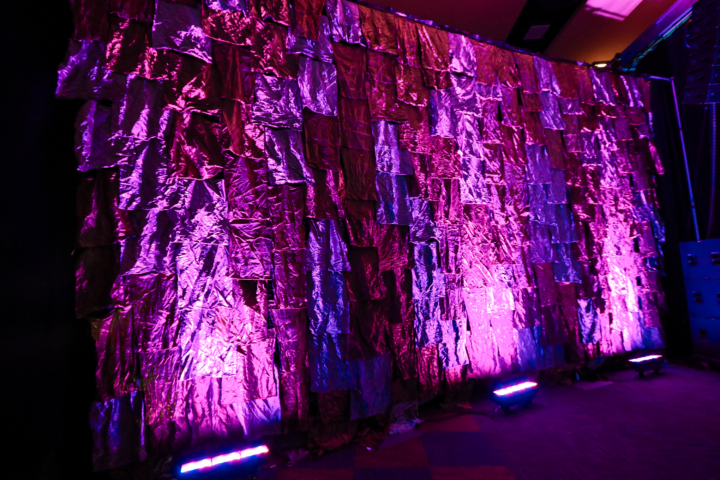 textured backdrop curtain with purple and pink up lighting