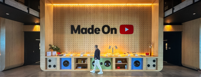 man walking past custom youtube display