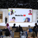 woman giving presentation in front of huge interactive screen