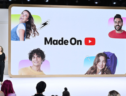 woman speaking in front of large interactive screen