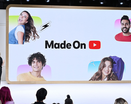 woman speaking in front of large interactive screen