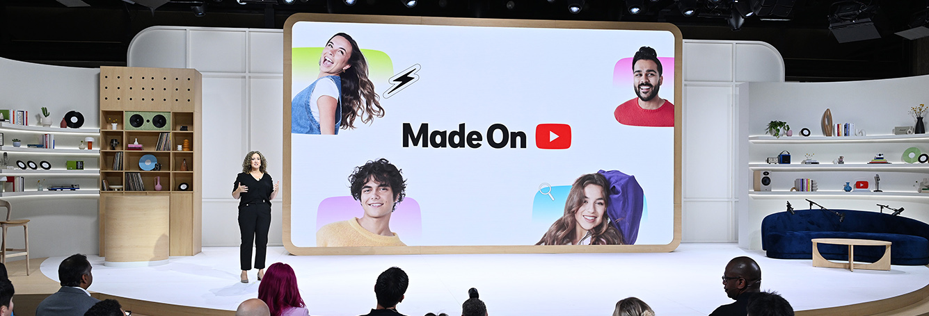 woman speaking in front of large interactive screen
