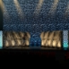 Rendering of a Extended wide view of Shell modular scenic wall installed across a large stage environment under overhead lighting.