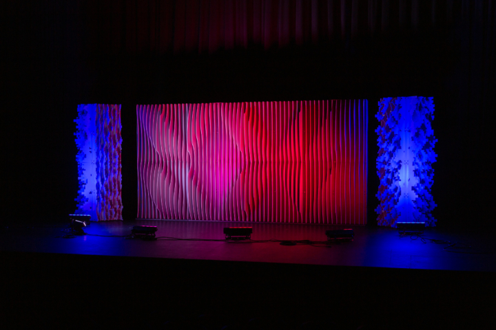 Pixel modular scenic wall installed on stage under red lighting.