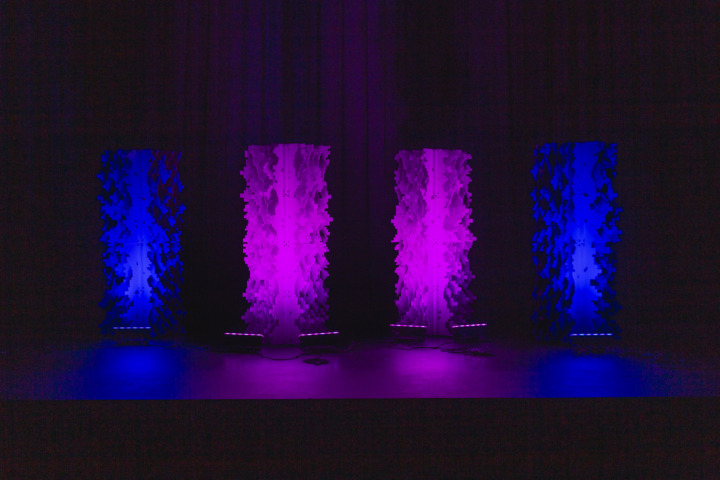 Pixel modular scenic wall with vertical lighting columns creating segmented illumination.