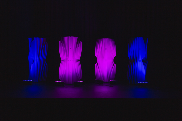 Shell modular scenic panels arranged in separated vertical configurations under purple lighting.