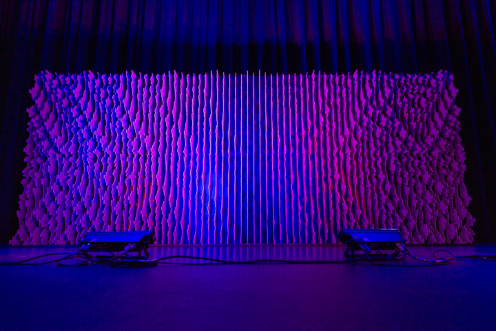 Front-facing Pixel modular scenic wall on stage with even vertical lighting.