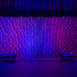 Front-facing Pixel modular scenic wall on stage with even vertical lighting.