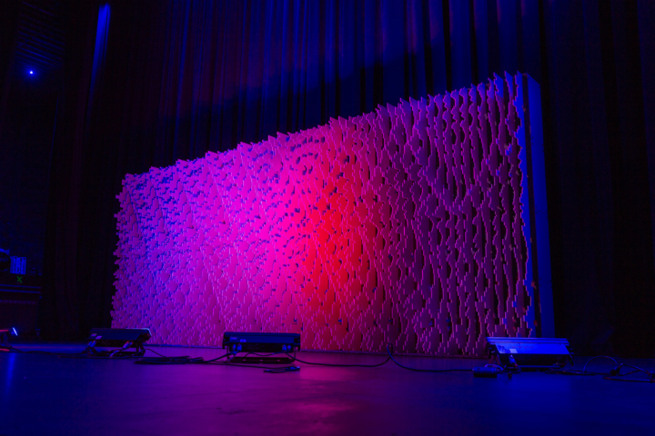 Wide stage installation of Pixel modular scenic panels under blue lighting.