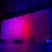 Wide stage installation of Pixel modular scenic panels under blue lighting.