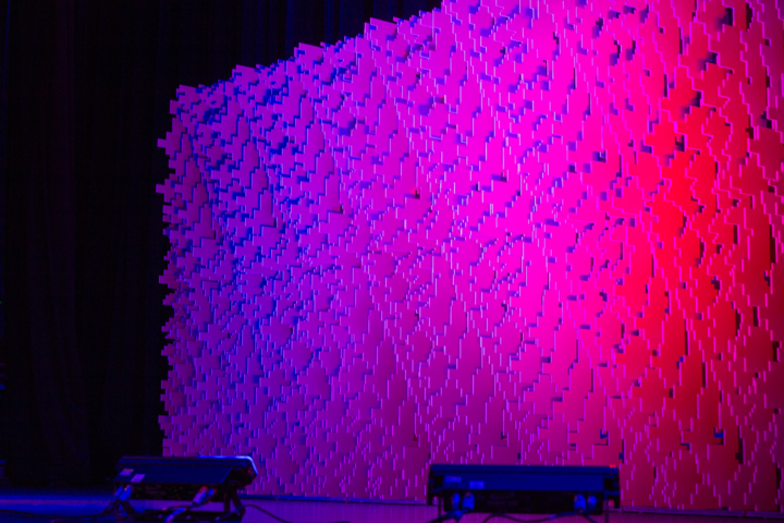 Full-width Pixel modular scenic wall installed on a stage with pink and blue gradient lighting.