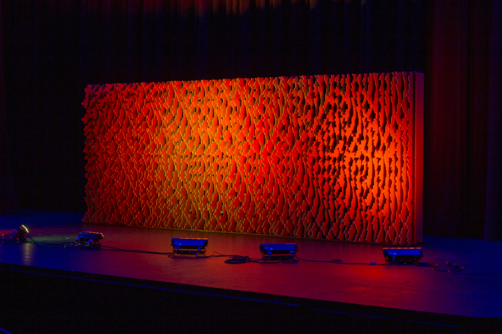 Front-facing view of a full-width Pixel modular scenic wall installed on a stage.
