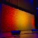 Wide angled stage installation of Pixel modular scenic panels with warm color wash lighting.