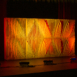 Full-width Shell modular scenic wall with warm orange lighting.