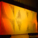 Full-width Shell modular scenic wall on stage with warm amber lighting.