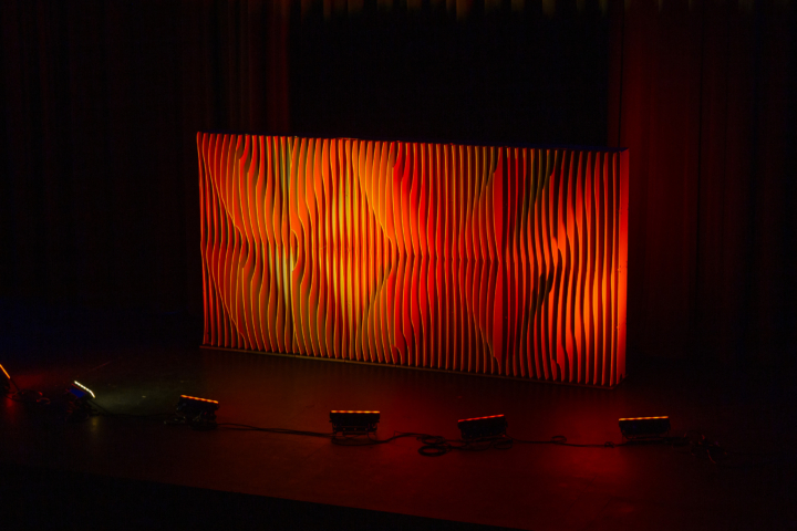 Shell modular scenic wall installed on stage under red lighting.
