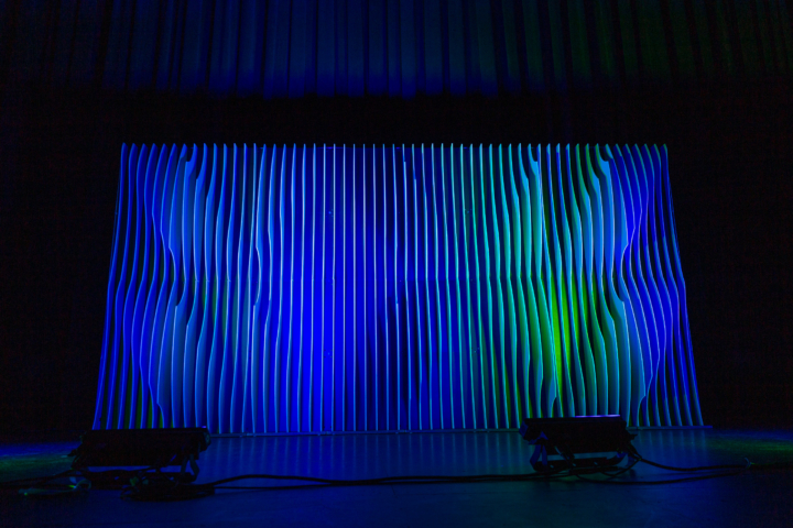 Shell modular scenic wall installed on stage under blue lighting.