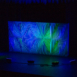 Full-width Shell modular scenic wall installed on a stage with blue and green lighting.