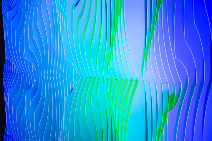 Detailed view of Shell modular scenic panel with green lighting highlighting surface curvature.