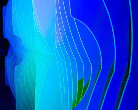 Close-up of Shell modular scenic panel showing curved surface geometry under blue and green lighting.